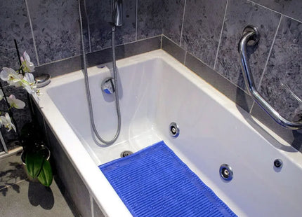 Anti-slip blue bath mat placed in a luxurious bathtub, enhancing comfort and safety during showers.